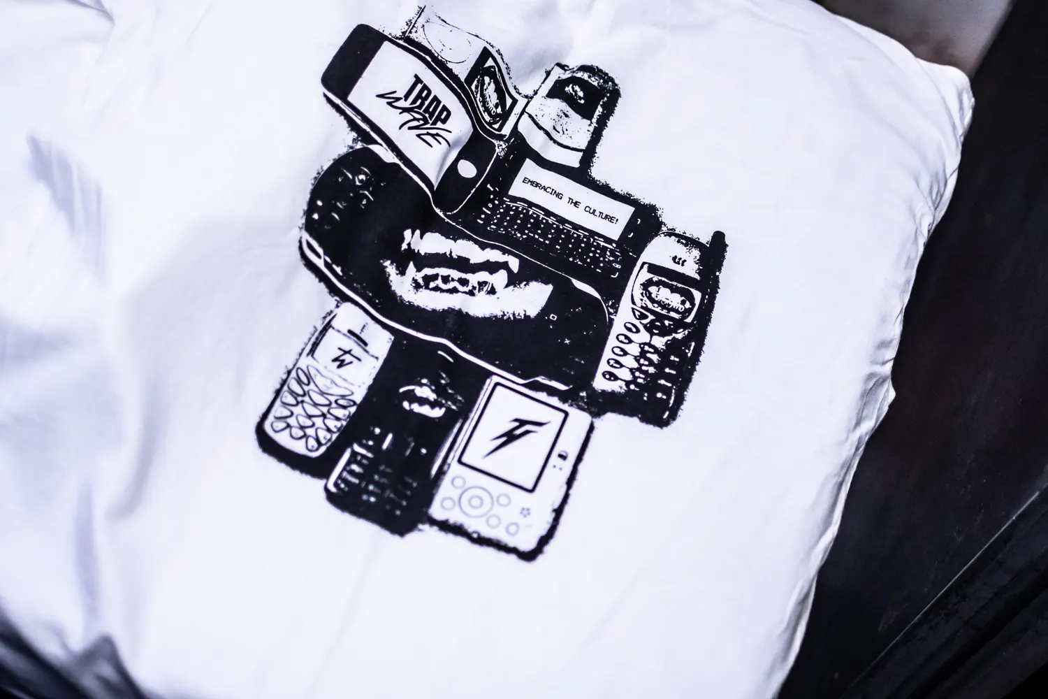 A white tee folded to show the phones print across the back.