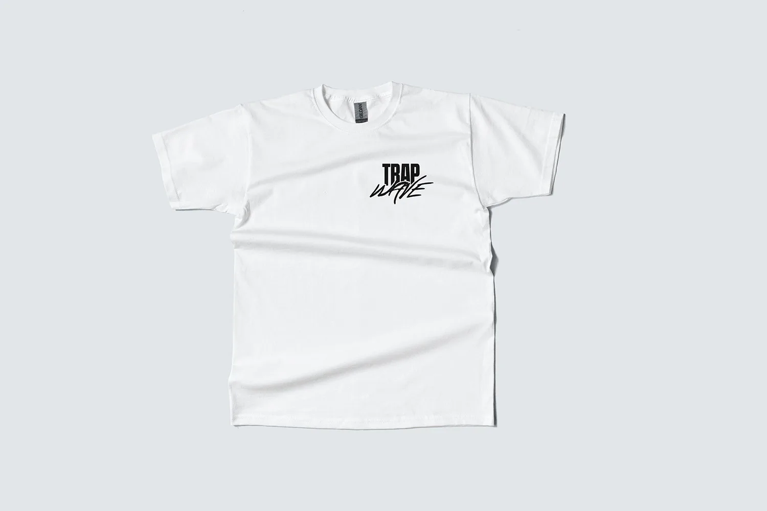 The white tee, wordmark printed small on the left chest.