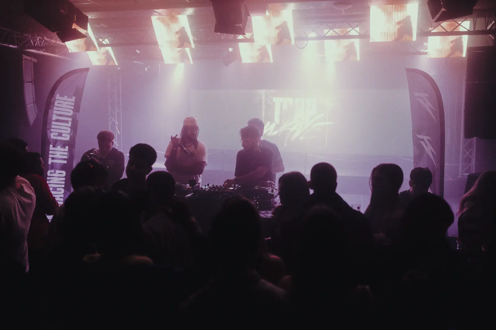The stage at Simplon, the booth backlit and the flags either side.