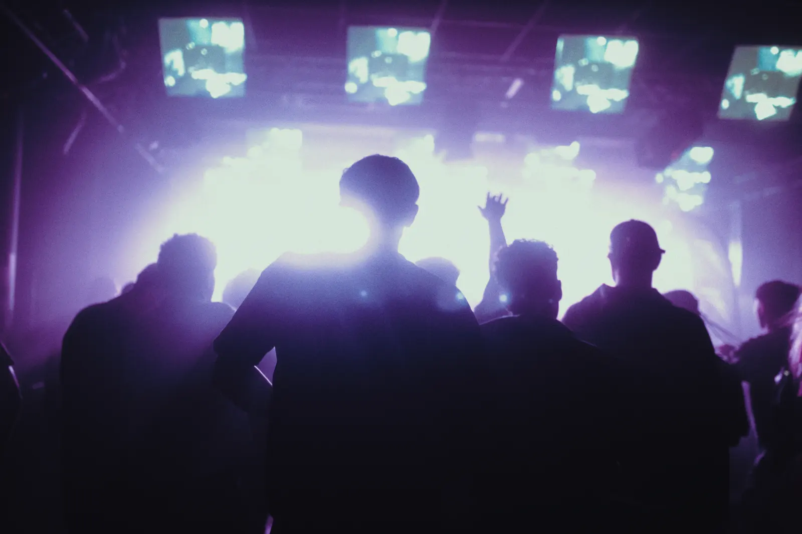 A silhouetted crowd against the screen wall at Simplon.